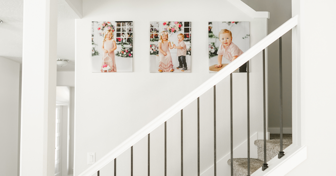 Three canvas prints hung above a staircase