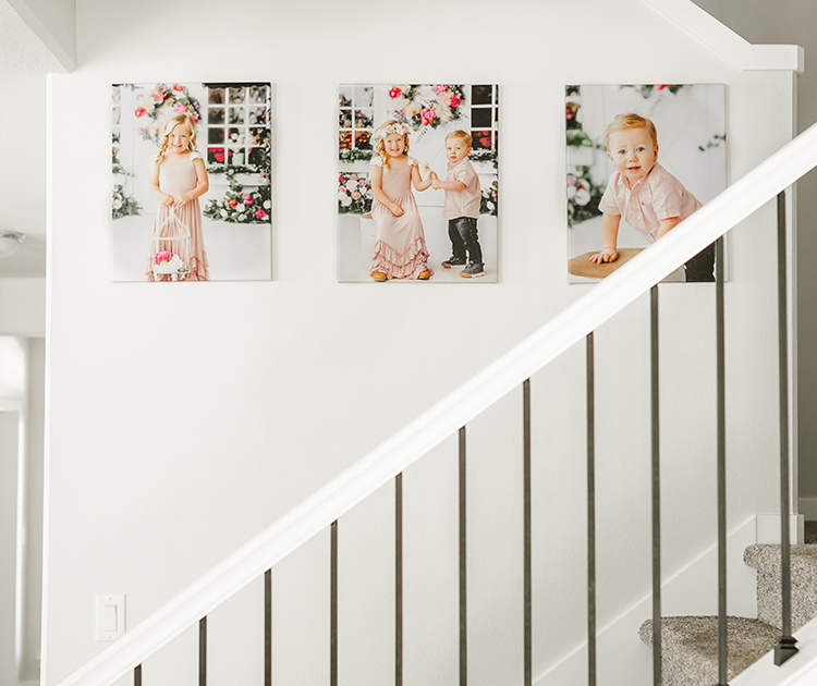 Three canvas prints hung above a staircase
